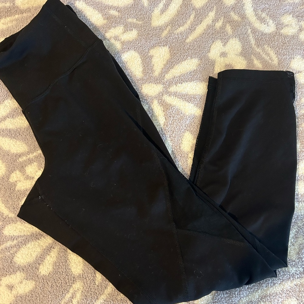 Black leggings with mesh on the side.